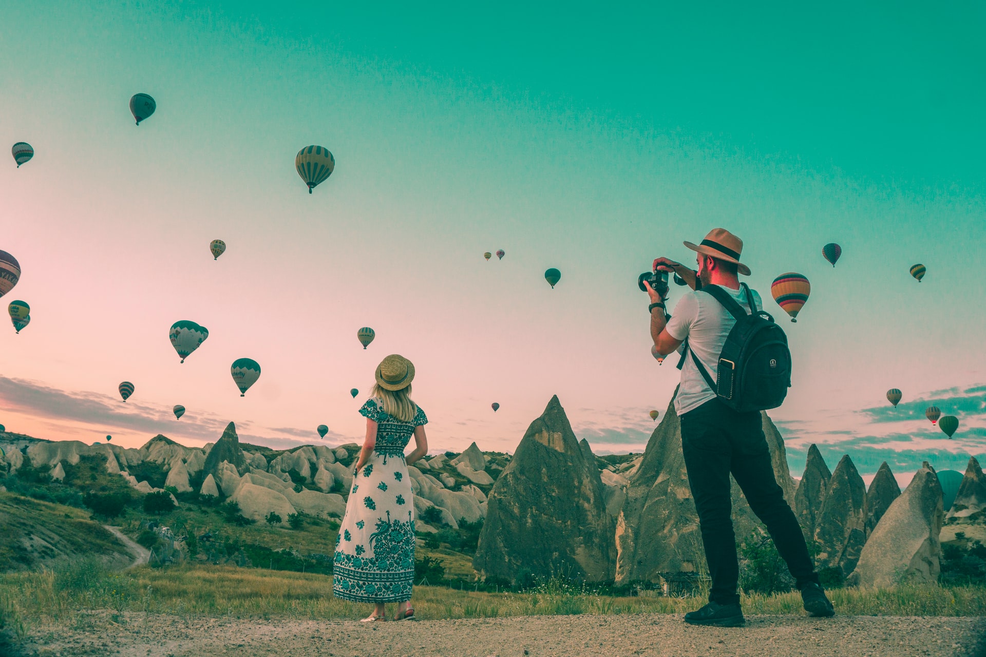 photographer taking picture of model in front of air balloons