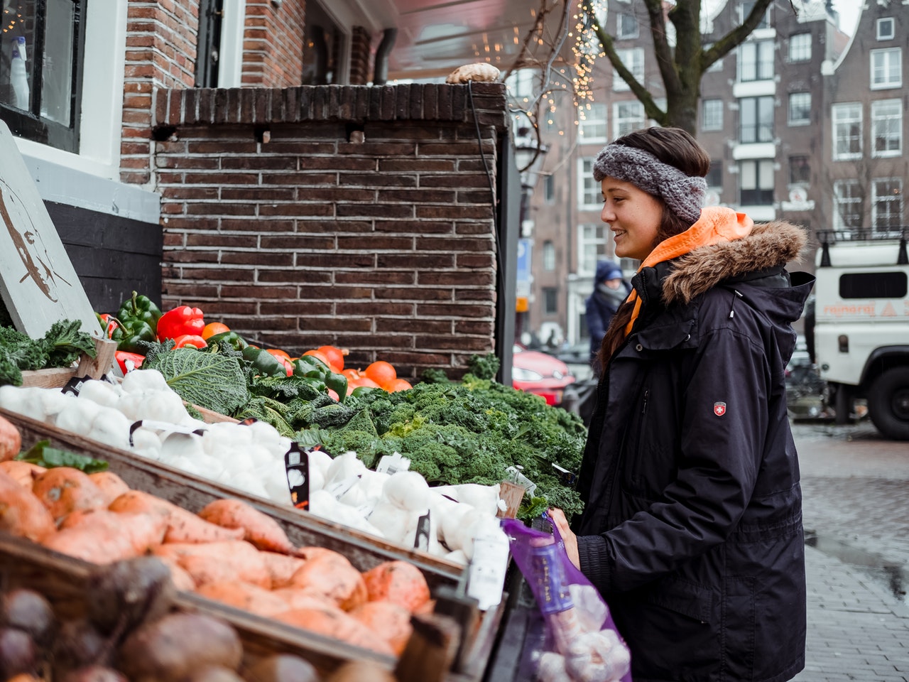 woman shopping for local groceries on street market
